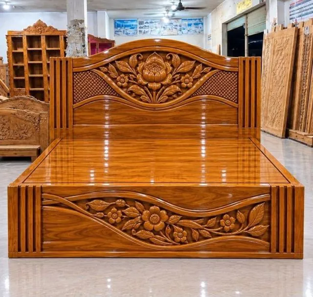 Carved teak bed with floral headboard